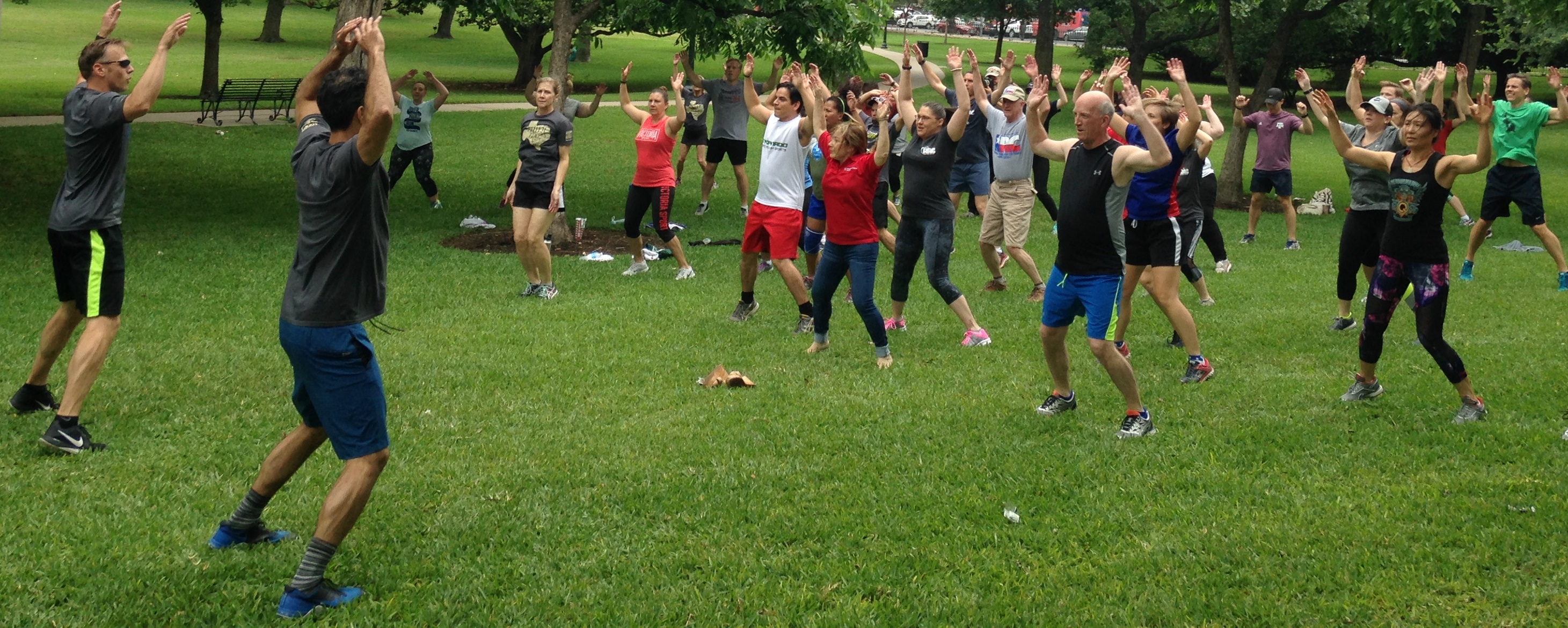 Railroad Commissioner Ryan Sitton (Left) and Texas Land Commissioner George P. Bush lead a state employee exercise class on the Capitol lawn